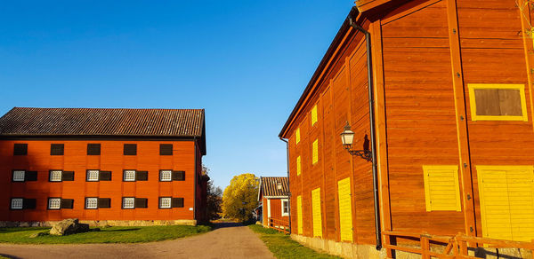 Residential buildings against clear blue sky