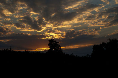Silhouette of landscape against cloudy sky