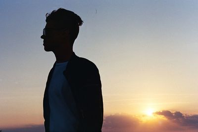 Man standing against sky during sunset