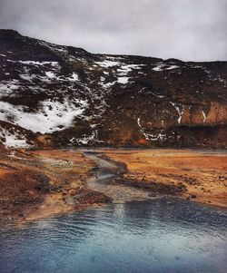 Scenic view of lake against sky during winter