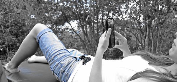 Low section of woman relaxing on tiled floor