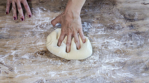 High angle view of hand holding ice cream on table