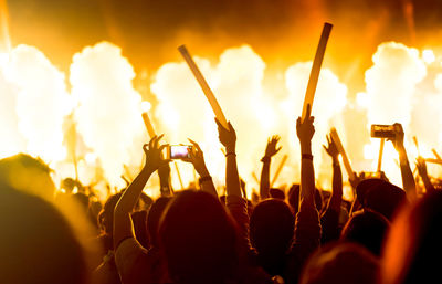 Rear view of people enjoying at music concert