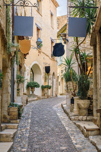 Footpath amidst buildings in city