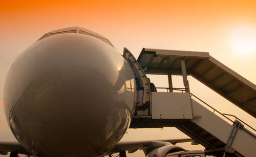 Airplane against sky during sunset