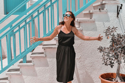 Full length of woman standing on staircase