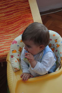 High angle view of cute baby relaxing at home