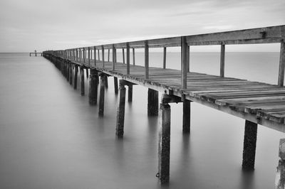 Pier over sea against sky