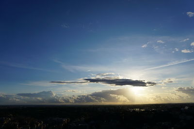 Sunlight streaming through clouds in sky