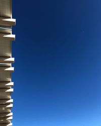 Low angle view of building against clear blue sky