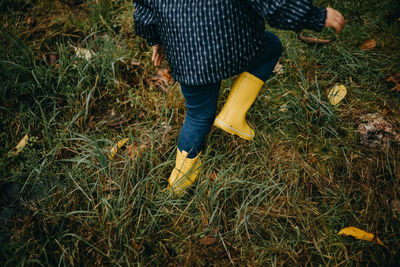 Close up child with yellow rubber boots