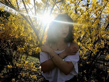 Woman standing by trees during autumn