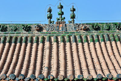 Low angle view of sculpture against clear blue sky