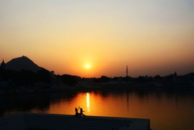 Scenic view of river at sunset