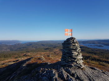 Stack of rocks against national flag