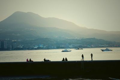 Scenic view of river with mountains in background