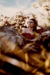 Portrait of young woman lying down outdoors