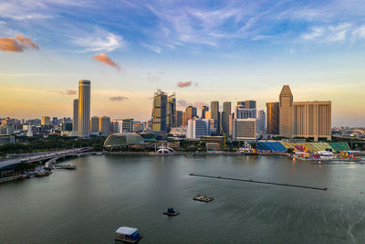 View of city buildings against sky during sunset