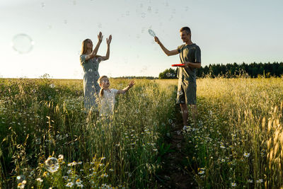 Rear view of woman standing on field