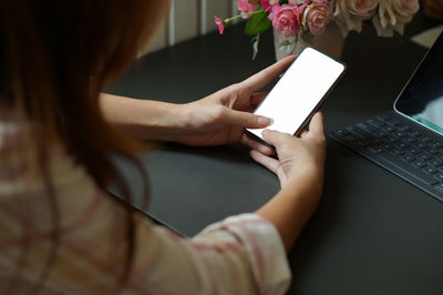 Midsection of woman using mobile phone