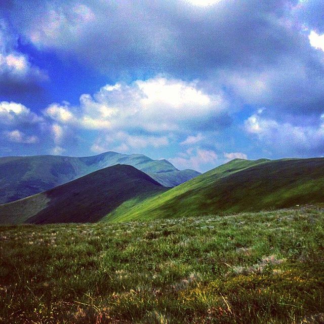 mountain, sky, tranquil scene, mountain range, landscape, tranquility, scenics, cloud - sky, beauty in nature, grass, cloudy, cloud, nature, non-urban scene, idyllic, remote, countryside, green color, hill, grassy