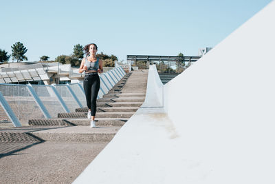 Female athlete running on steps