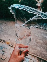 Midsection of person drinking glass with water