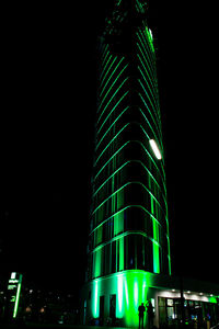 Low angle view of illuminated building against sky at night