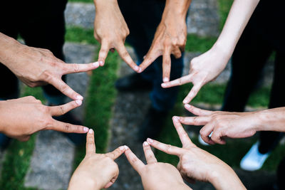 Cropped image of people hands against blurred background
