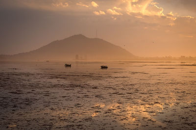 Scenic view of beach against sky during sunset