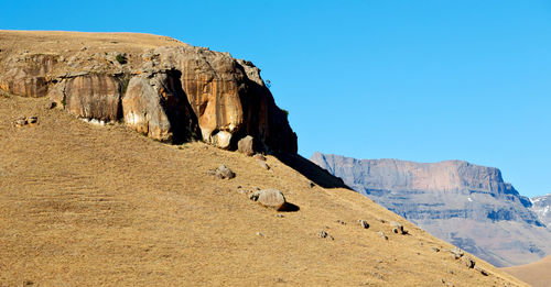 Scenic view of rocky mountains against clear blue sky