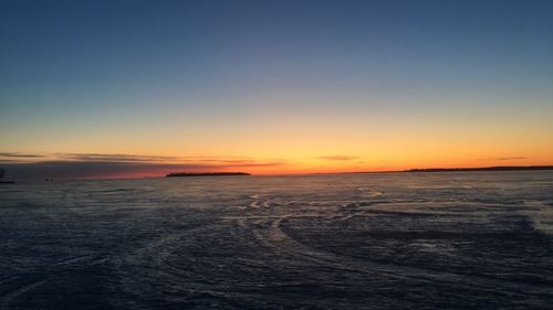 Scenic view of sea against clear sky during sunset