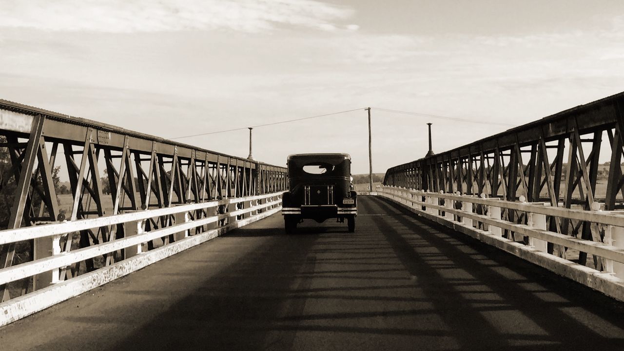 transportation, bridge - man made structure, architecture, built structure, connection, railing, the way forward, sky, men, lifestyles, engineering, travel, bridge, diminishing perspective, rail transportation, mode of transport, incidental people, walking