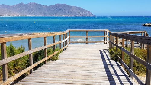 Pier over sea against clear sky