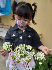 Close-up of girl playing with bouquet