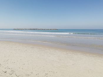 Scenic view of beach against clear sky