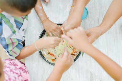 Midsection of friends stacking hands