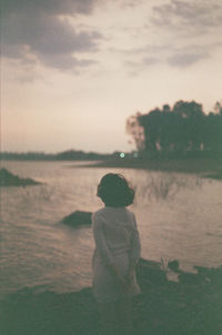 Rear view of boy standing on beach