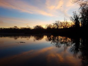 Scenic view of lake against sky during sunset