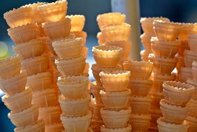 Close-up of ice cream cones stacked outdoors