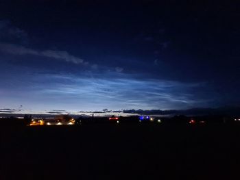 Illuminated city against sky at night