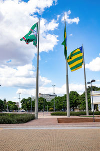 Low angle view of flag flags against sky