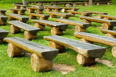 High angle view of wooden bench on field