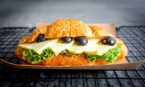 Close-up of croissant, breakfast served on cooling rack 