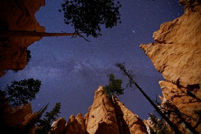 Low angle view of rock formation against sky at night