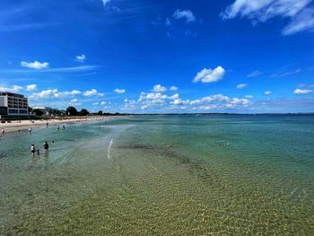 Scenic view of beach against blue sky