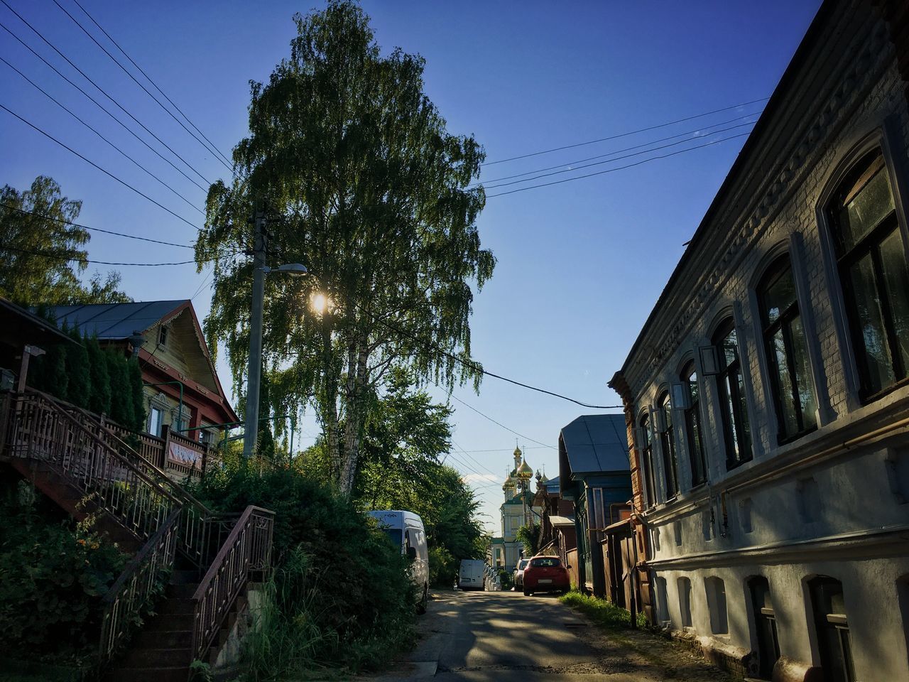 ROAD AMIDST BUILDINGS AGAINST SKY