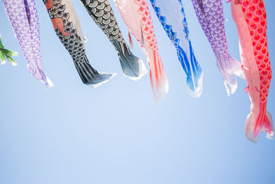 Low angle view of koinobori against clear sky