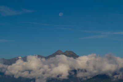 Scenic view of mountains against cloudy sky