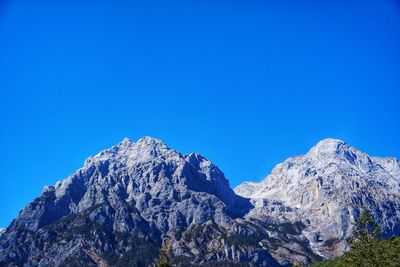 Scenic view of mountains against clear blue sky